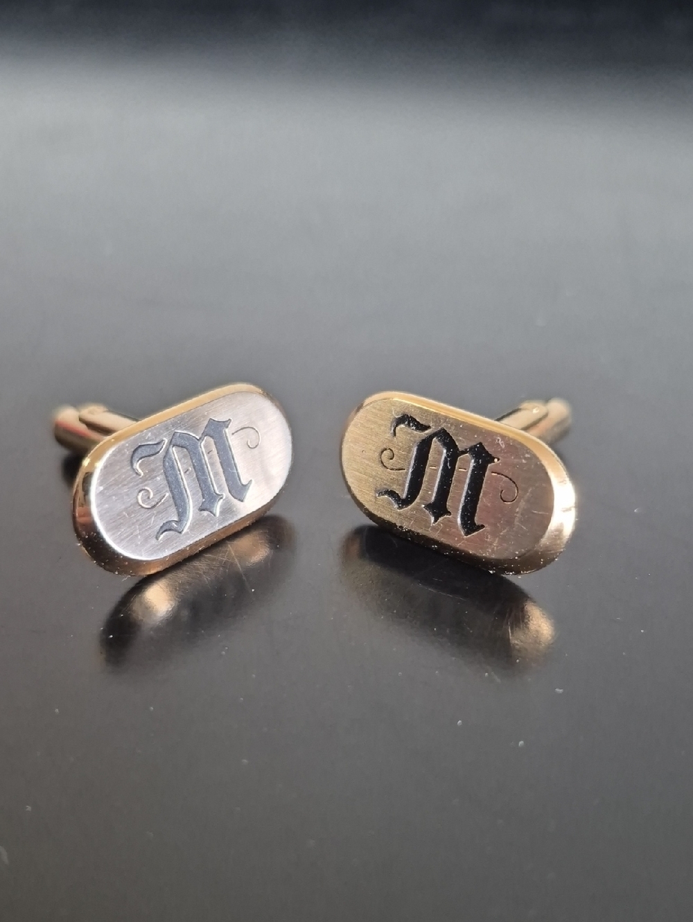 Gold Tone Oval Cufflinks with Black 'M' Monogram